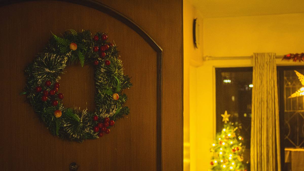 Stylish indoor wreaths home decorating above a modern console table with layered textures